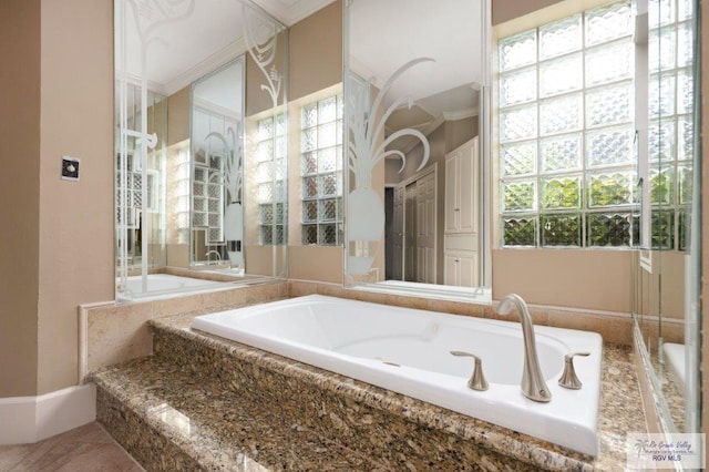 bathroom with a relaxing tiled tub