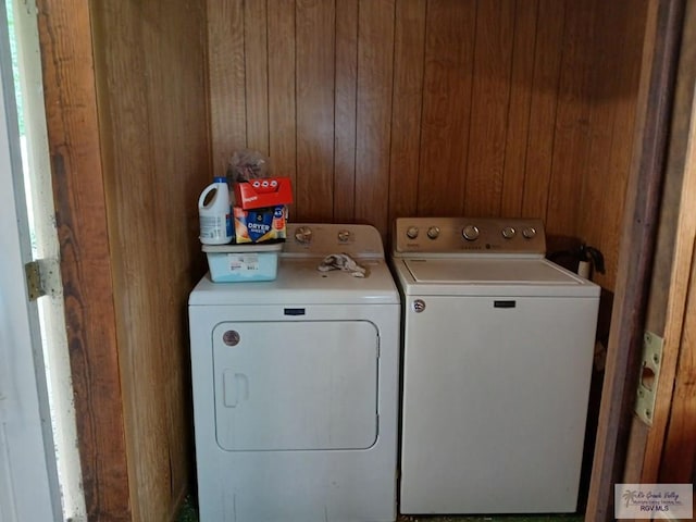 washroom featuring washer and dryer and wood walls