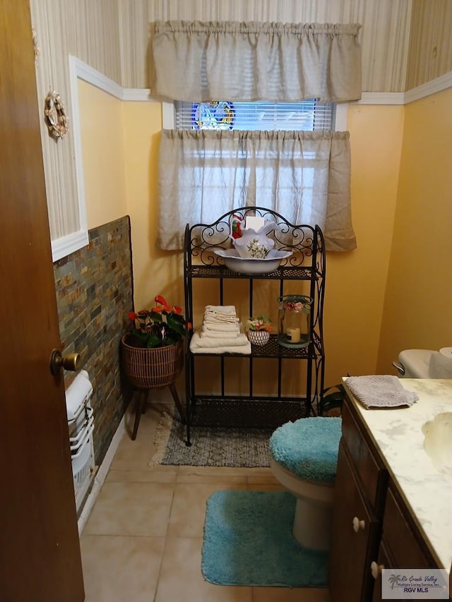 bathroom featuring toilet, tile patterned flooring, and vanity