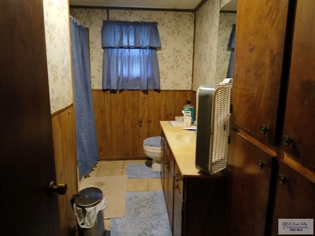 bathroom with vanity, tile patterned flooring, and toilet