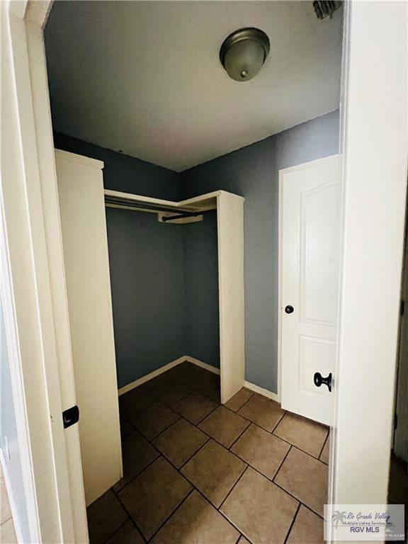 walk in closet featuring tile patterned flooring