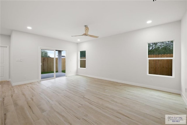 spare room featuring light wood-type flooring and ceiling fan