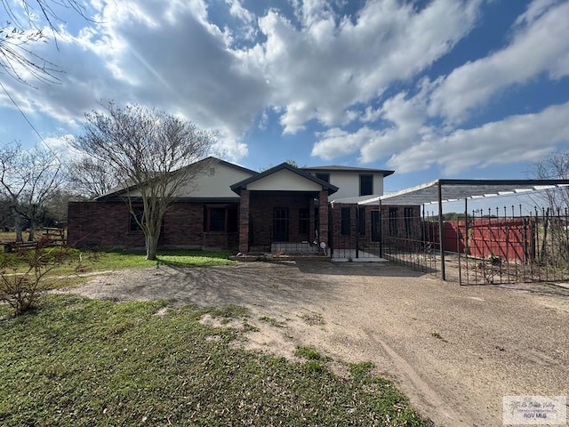 view of front of house with brick siding and fence