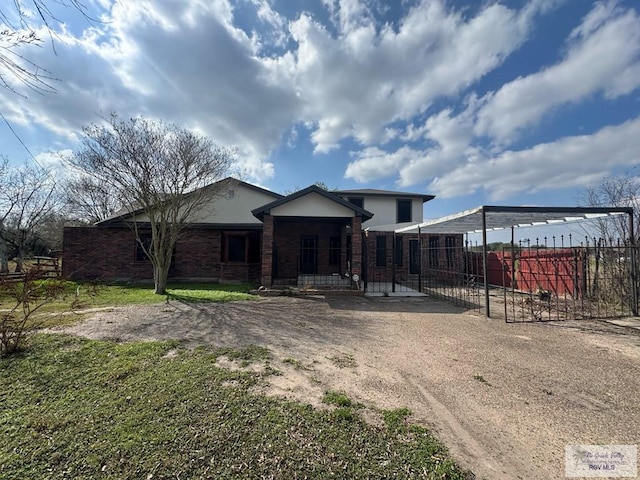 view of front of property with fence and brick siding