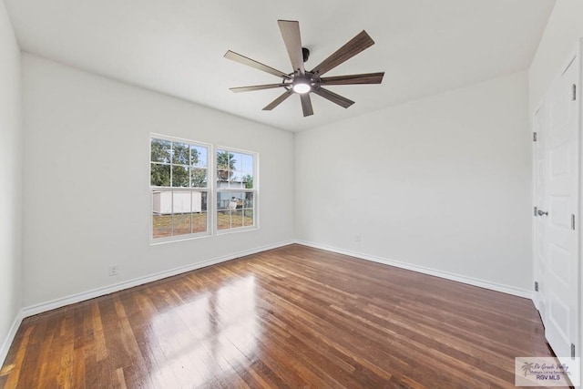 spare room with ceiling fan and dark hardwood / wood-style floors