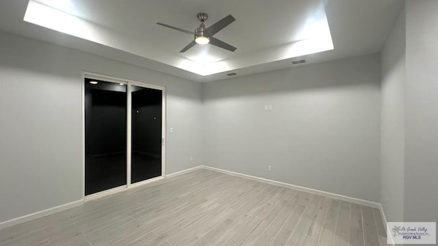 spare room with ceiling fan and light hardwood / wood-style floors