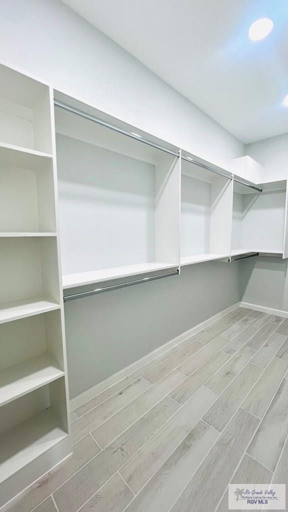 spacious closet featuring hardwood / wood-style floors