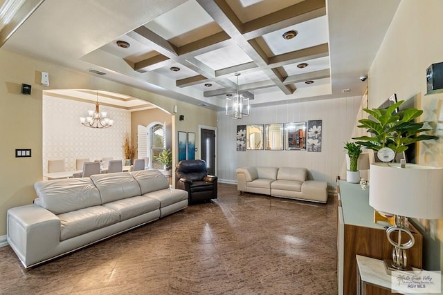 living room featuring beamed ceiling, coffered ceiling, and a chandelier