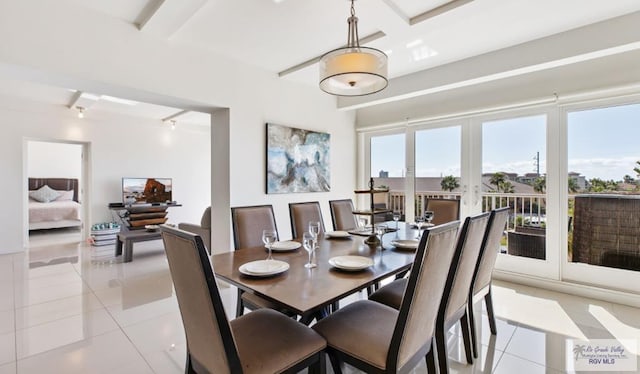 dining area with french doors, light tile patterned floors, and track lighting