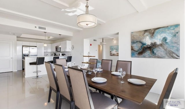 dining space featuring light tile patterned floors