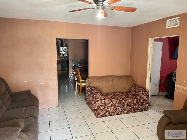 tiled living room with ceiling fan