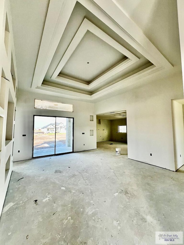 unfurnished living room with a raised ceiling