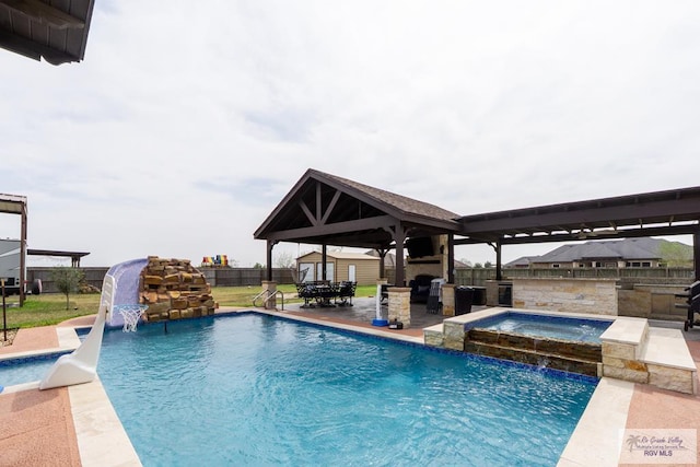 view of swimming pool with a gazebo, fence, exterior fireplace, and area for grilling