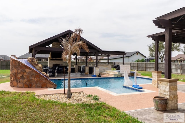 view of swimming pool featuring an outdoor kitchen, a fenced in pool, a patio, a fenced backyard, and a gazebo