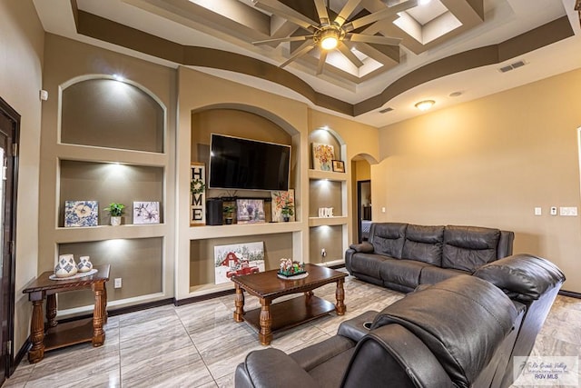 living area with arched walkways, built in shelves, coffered ceiling, and visible vents