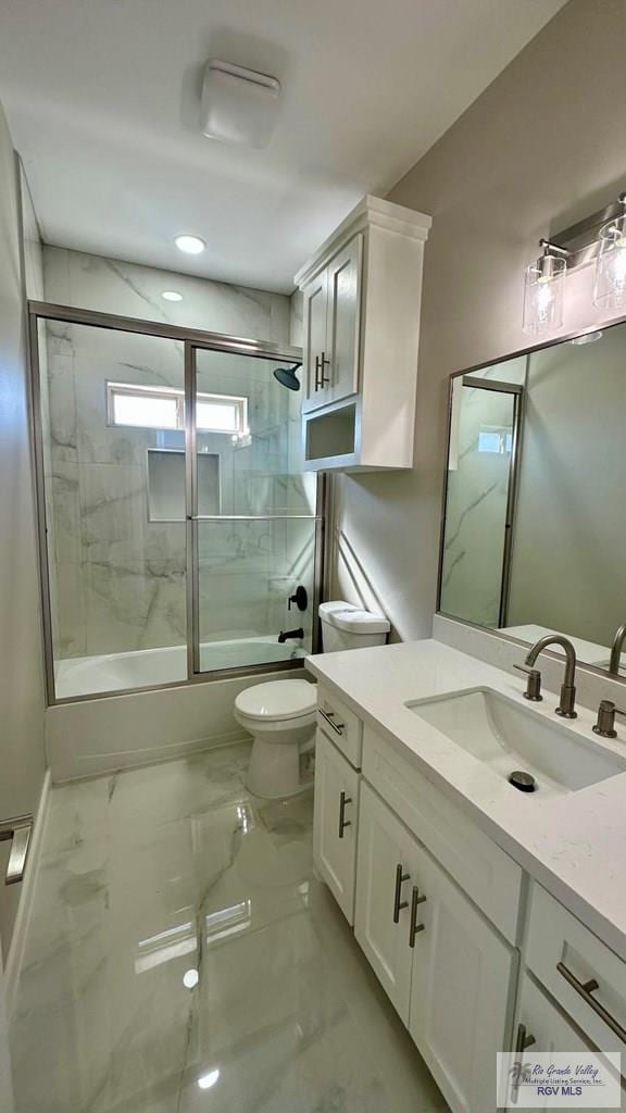 bathroom with marble finish floor, toilet, vanity, and bath / shower combo with glass door