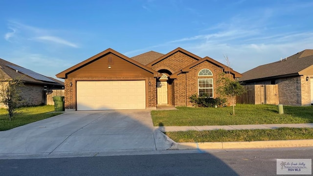 view of front of property with a front yard and a garage