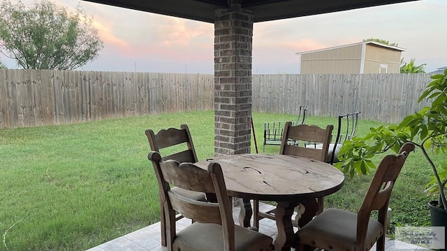 patio terrace at dusk with a lawn