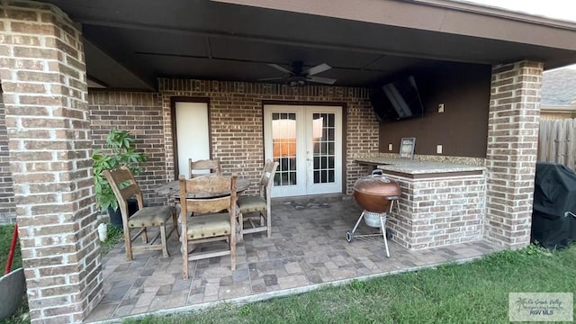 view of patio featuring area for grilling, ceiling fan, french doors, and an outdoor bar