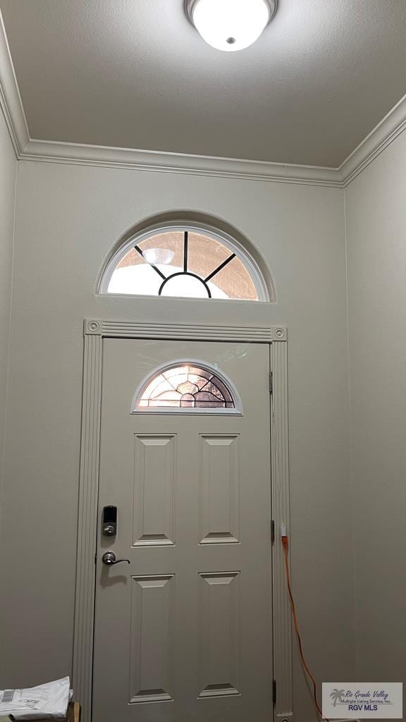 entrance foyer featuring ornamental molding