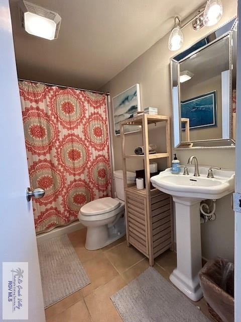 bathroom with tile patterned flooring and toilet