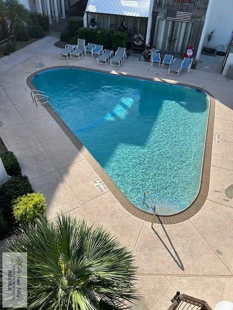 view of swimming pool featuring a patio area