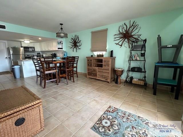 dining space featuring light tile patterned flooring