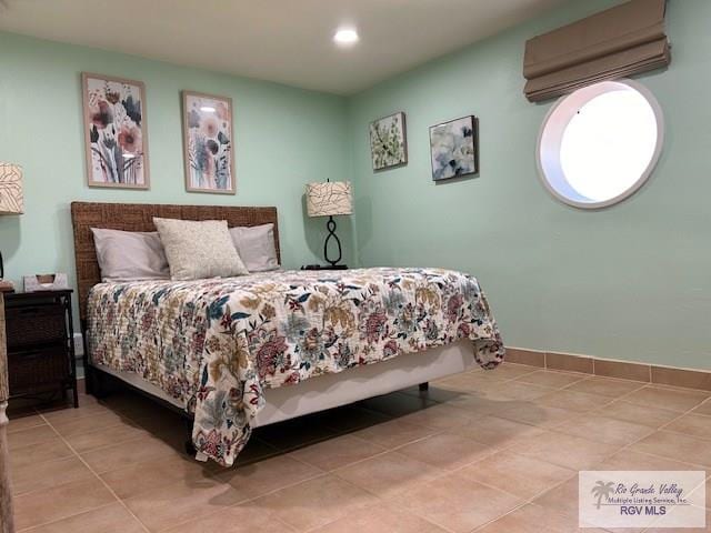 bedroom featuring light tile patterned flooring