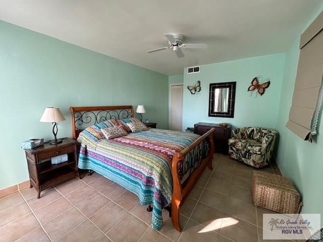 tiled bedroom featuring ceiling fan