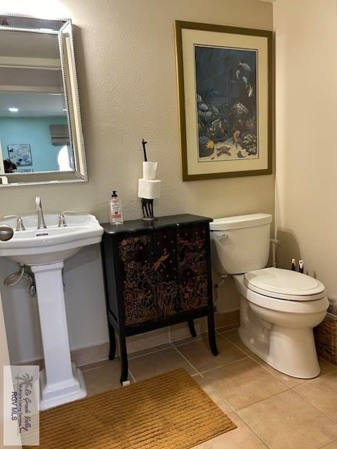 bathroom featuring tile patterned flooring and toilet