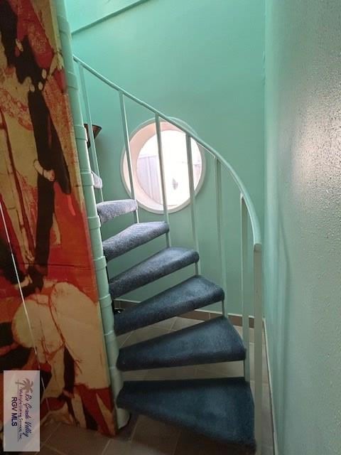 staircase with tile patterned flooring