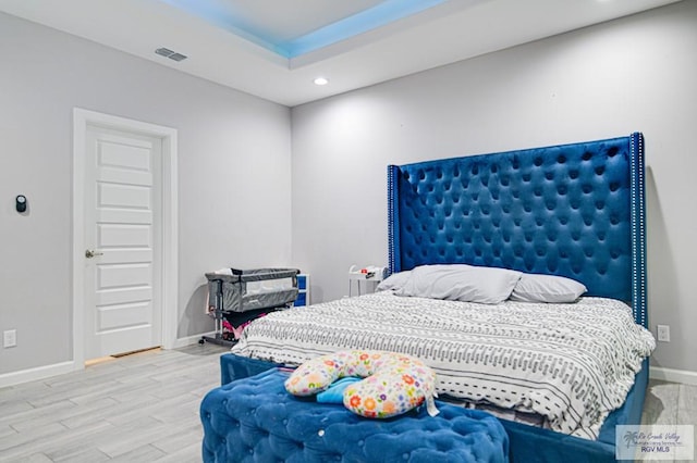 bedroom featuring baseboards, visible vents, wood finished floors, and recessed lighting