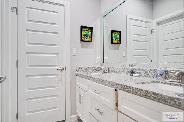 bathroom with double vanity and a sink