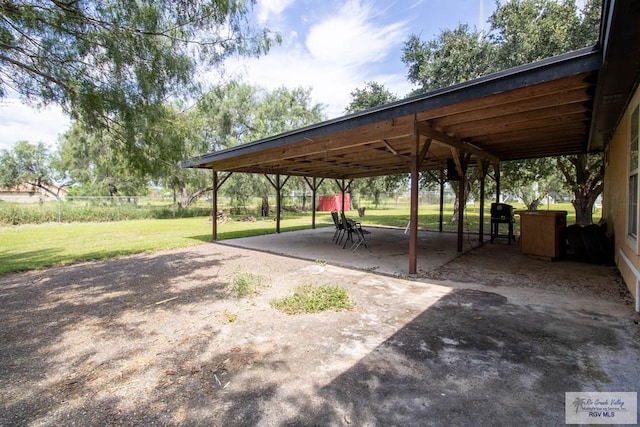 view of home's community featuring a patio area, a lawn, and driveway