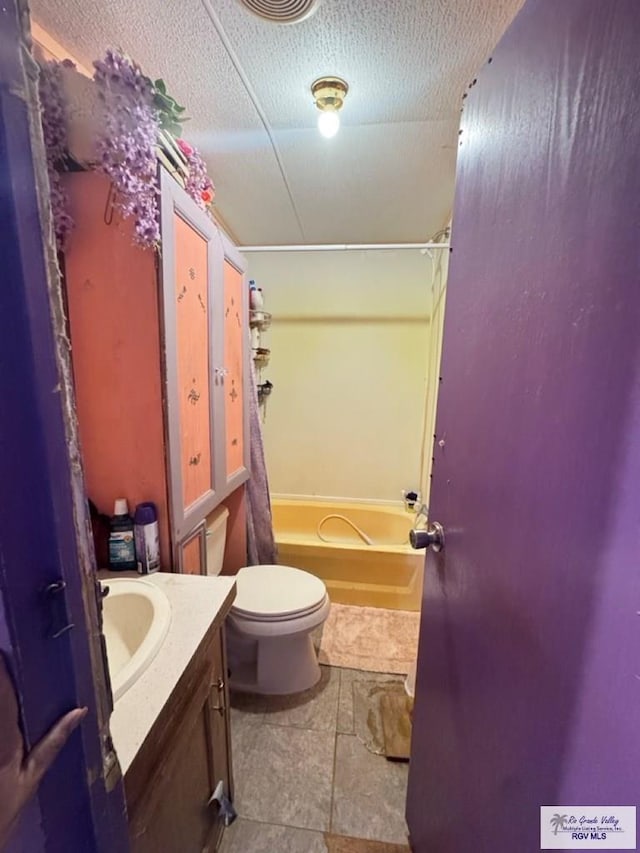 38639 Centerline Rd, Los Fresnos, TX 78566 - bathroom with vanity, shower / bath combo with shower curtain, tile patterned flooring, and a textured ceiling