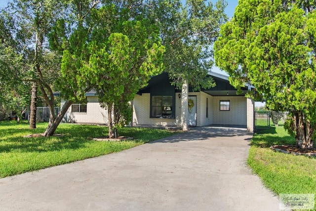 obstructed view of property featuring a front lawn and a carport