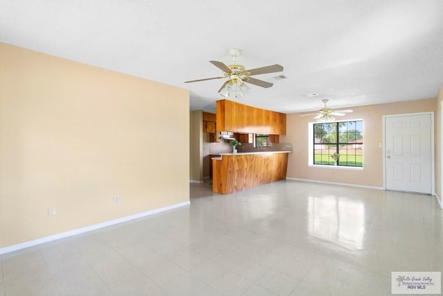 unfurnished living room with ceiling fan