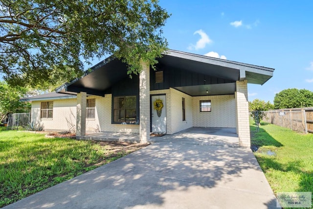 contemporary house with a front yard and a carport