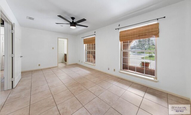 bathroom featuring toilet, tiled shower / bath combo, and tile patterned floors