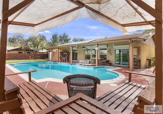 view of swimming pool featuring a patio, fence, and a fenced in pool