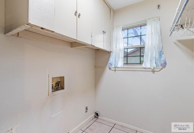 laundry area featuring cabinet space, light tile patterned floors, baseboards, hookup for an electric dryer, and washer hookup