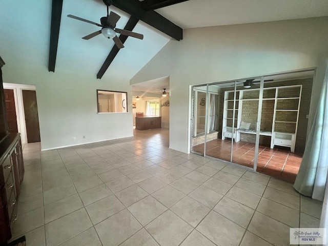 unfurnished living room with beam ceiling, high vaulted ceiling, ceiling fan, and light tile patterned flooring