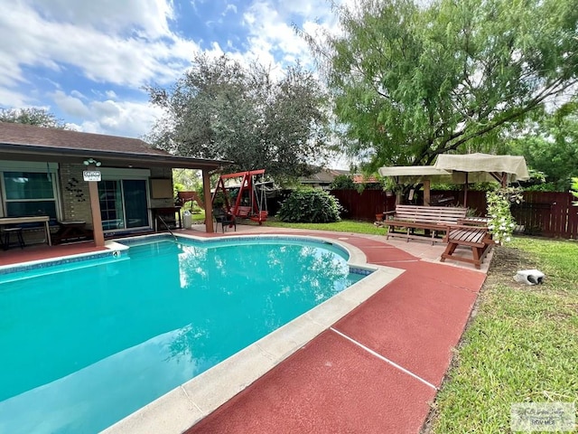 view of swimming pool with a patio