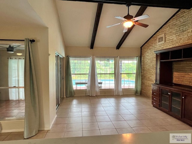 interior space featuring brick wall, ceiling fan, high vaulted ceiling, beamed ceiling, and light tile patterned flooring