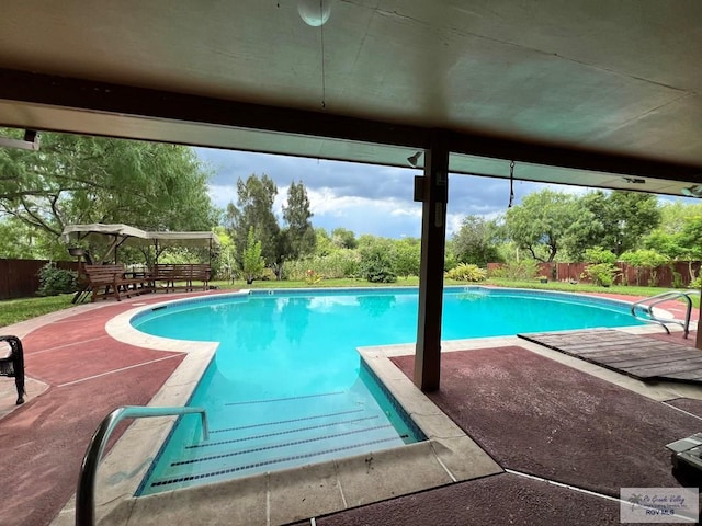 view of swimming pool with a deck