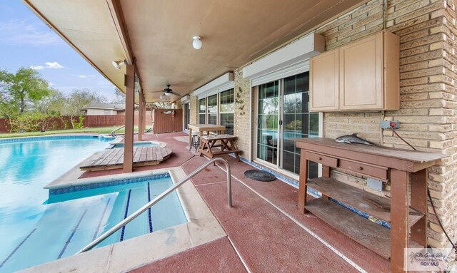 view of pool featuring ceiling fan and a patio