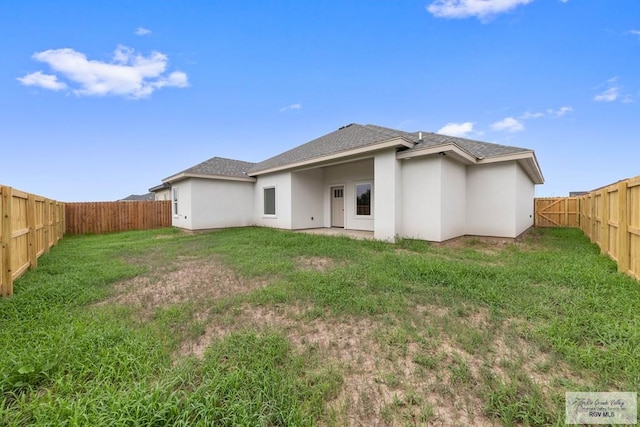 rear view of property featuring a yard