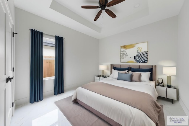 bedroom featuring a tray ceiling and ceiling fan