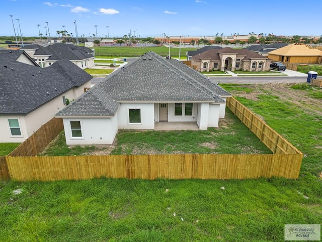 back of property featuring a patio and a lawn