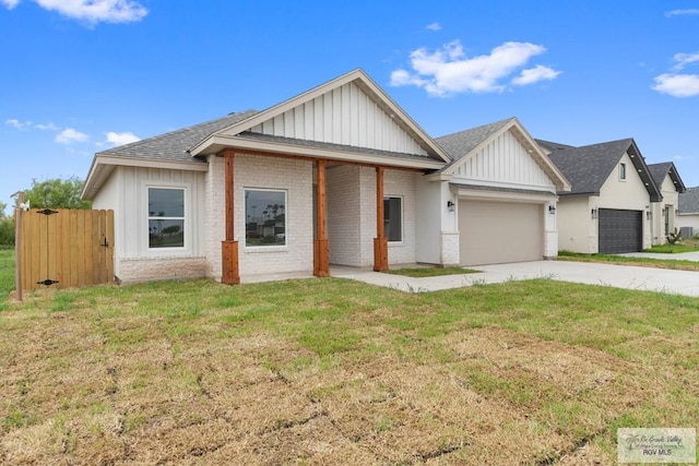 view of front of home with a garage and a front lawn